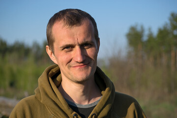 man portrait. the guy against the backdrop of nature. photo, smiling, thoughtful, surprised,...