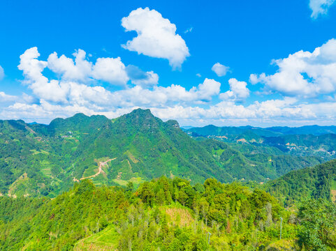 Landscape of mountains, blue sky and white clouds in Fengshan, Hechi, Guangxi - Powered by Adobe