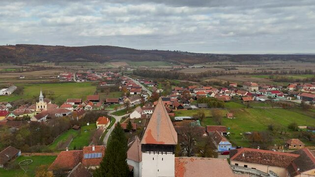 Marvel at the scenic beauty of Hosman Fortified Church in Transylvania, Romania, with this sweeping drone footage in landscape mode.