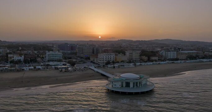 Drone aerial hyperlapse orbiting Senigallia's iconic Rotonda a Mare during a serene .