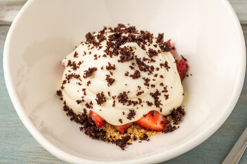 Top view of Strawberry magnolia dessert in white porcelain bowl
