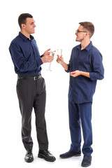 Young men with champagne on white background. New Year celebration