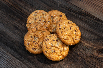 Heart shaped cookies on a wooden table, sweet homemade Heart-shaped cookies with oat flakes. Oatmeal cookies with sesame seeds. oatmeal cookies with seeds on a wooden table