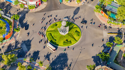 A difficult road intersection.

A drone shot from above of the intersection in Nha Trang in Vietnam of 7 roads. In the center of the intersection there is a flower bed in the shape of a star and a lig