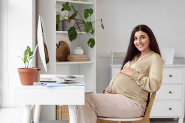 Pregnant businesswoman working at home office