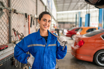 Female Auto mechanic are checking and repair maintenance auto engine is problems at car repair shop.