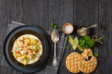 seafood chowder in a white bowl, top view