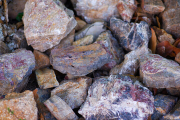 Soil, rocks, sand, damaged asphalt roads