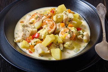 seafood chowder in a white bowl, top view