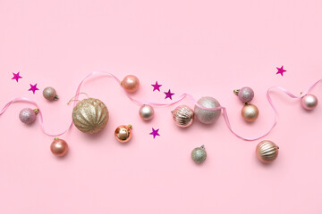 Beautiful composition with Christmas balls, confetti and ribbon on pink background