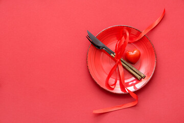 Beautiful table setting with red rose and heart on color background. Valentine's Day celebration