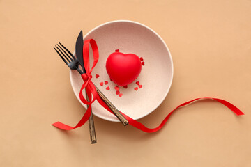 Beautiful table setting with heart on brown background. Valentine's Day celebration