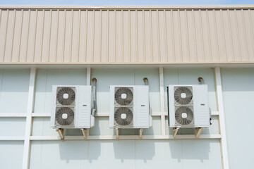 Air compressor or air condenser unit located on support outside building to heat released...