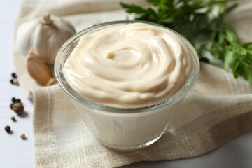 Bowl with mayonnaise and ingredients for cooking on gray background