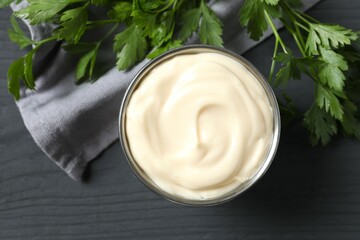 Bowl with mayonnaise and ingredients for cooking on wooden background