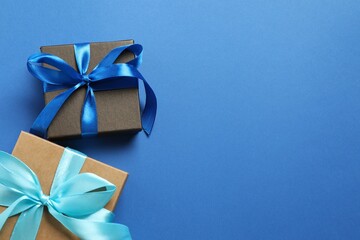 Beautiful gift box tied with bow on color background 