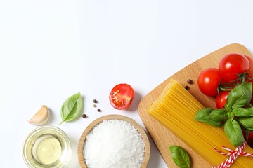 Composition with pasta and cooking ingredients on white background, top view