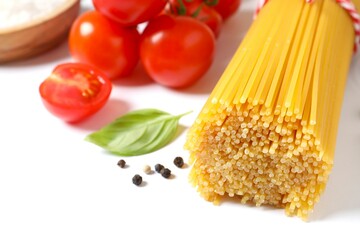 Composition with pasta and cooking ingredients on white background, top view