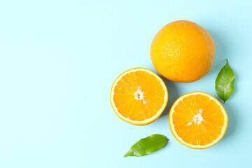 Fresh orange citrus fruit with leaves on colored background