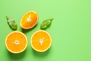 Fresh orange citrus fruit with leaves on colored background