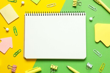 Flat lay with notebook and school stationery on color background, top view