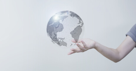 白い明るい背景と日本人女性の手と線画の地球のテクノロジーのホログラムのCGグラフィックス