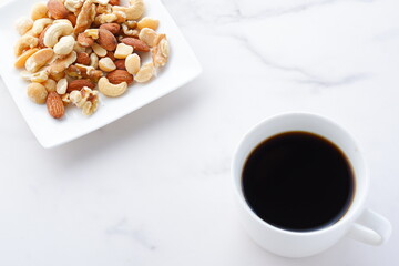 ミックスナッツ（アーモンド、クルミ、カシューナッツ、マカダミアナッツ）と、淹れたてのコーヒー
