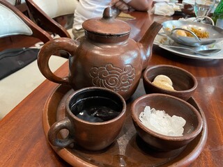 Indonesian Traditional Tea Ceremony: Clay Teapot and Cups with Sweeteners