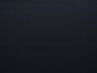 Empty black background of textured synthetic carpet