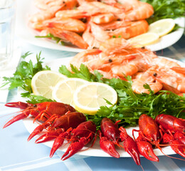 Cooked shrimp and crayfish on plate close up