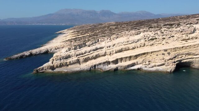 Aerial Orbit of Matala Coastal Cliff and Beach Bay, Crete, Greece