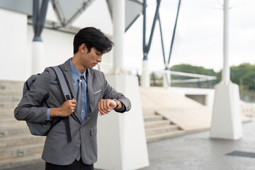 Asian Male Professional Checking Watch in Urban Setting