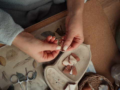 Hands Sewing Teddy Toy Details, Horizontal Directly Above Close-Up