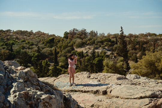 girl taking photo of nature