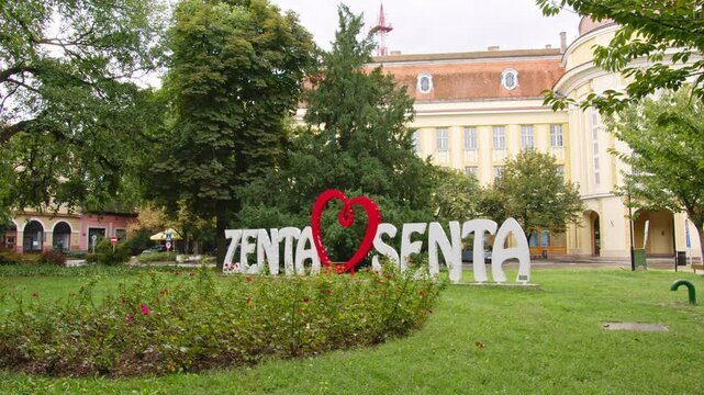 Explore the vibrant park of Zenta Senta featuring charming greenery and art installations in a serene atmosphere