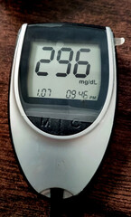 A close up of blood glucose meter with high sugar reading on woo