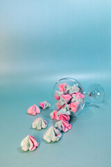Meringue. Sweets in a glass on a mint color background. Desserts. Sweets. Meringue in a glass