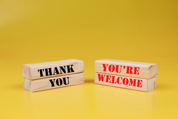 Thank you you're welcome symbol. Wooden blocks with words Thank you youre welcome. Beautiful yellow...