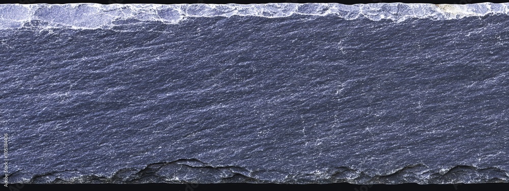 Poster the textured surface of a black rock, adorned with natural patterns, provides a unique backdrop for 