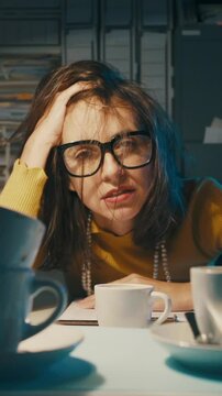 Exhausted stressed office worker having too many coffees