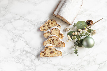 German Stollen for Christmas with powdered sugar marble table