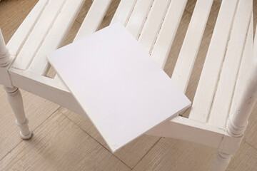 blank magazine cover mockup on wooden outdoor table, hotel balcony or terrace