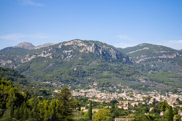 Obraz premium Soller village in Mallorca Spain surrounded by mountains on a sunny day with a blue sky