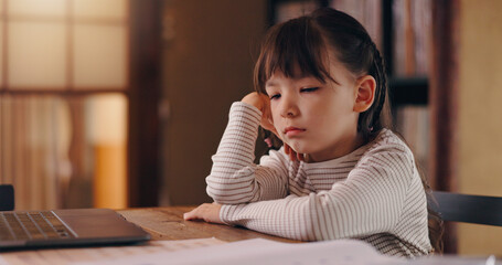 Girl, child and bored with homework, reading and frustrated with learning disability, tired or adhd in family house. Kid, sad and thinking with laptop, books and online course for education in Japan