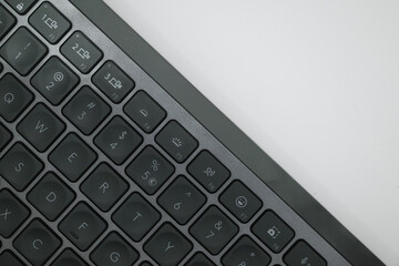 closeup of a black wireless bluetooth keyboard isolated on white background