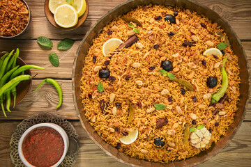 Arabic Cuisine; Arabic basmati rice with various of aromatic spices and dried limes. Served with delicious Daqoos sauce.