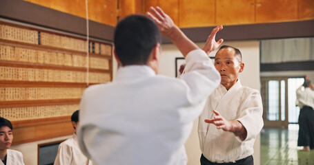 Man, martial arts and student in class for learning, safety training and start fight for self defense. Mature sensei, Japanese people and karate in dojo for traditional sport, lesson and discipline © peopleimages.com