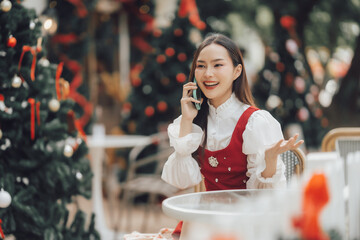 Christmas Cheer: A Happy Woman on a Festive Phone Call 