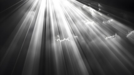 Dramatic monochrome sun rays breaking through clouds.