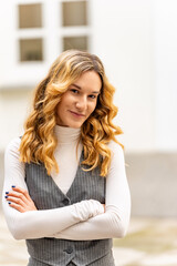 Fototapeta premium Portrait of a young businesswoman standing outdoors with crossed arms, exuding confidence and professionalism